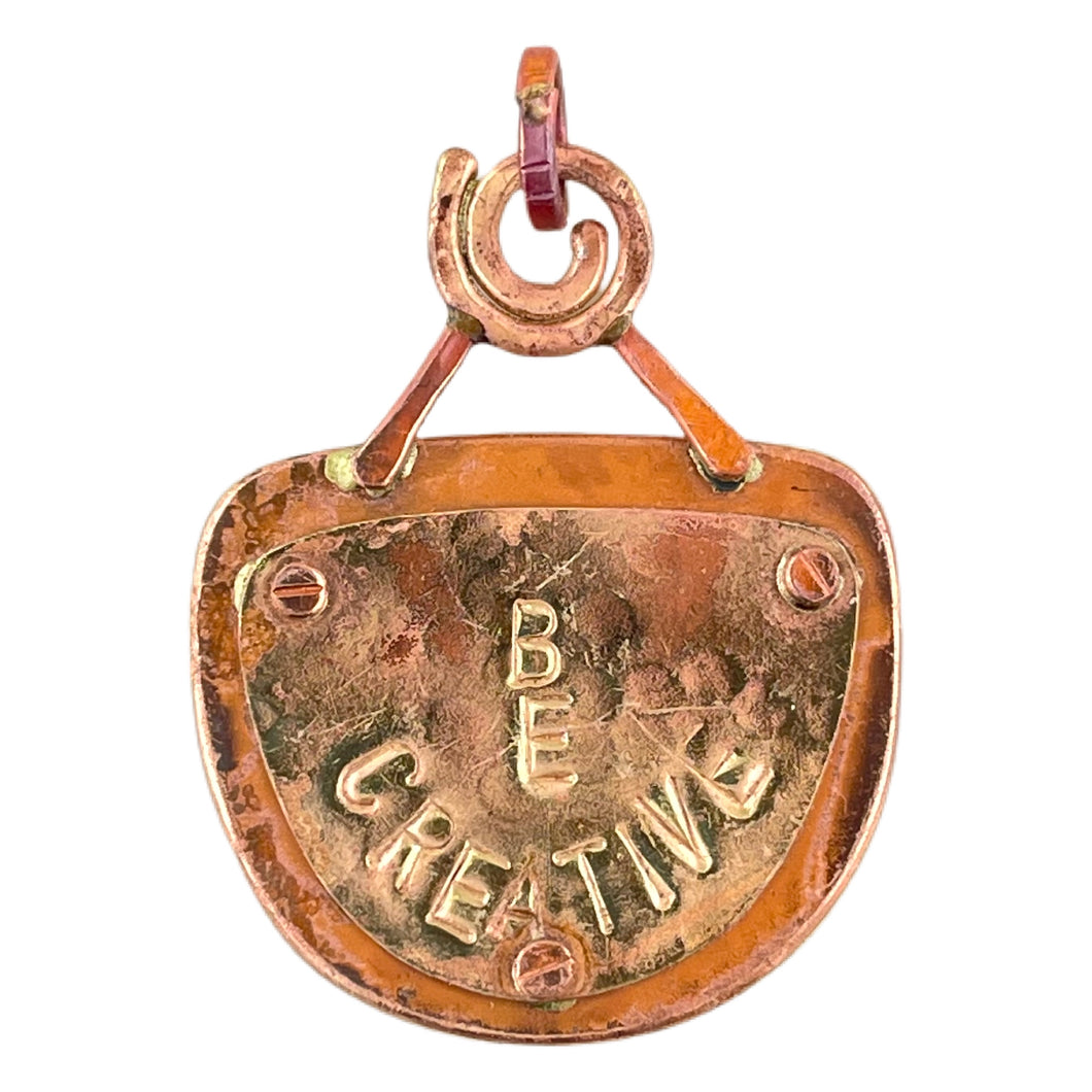 Reversible copper pendant with whimsical face on front and BE CREATIVE plaque on back, handmade by Patricia Healey