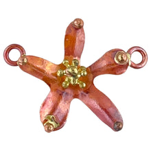 Handmade copper and brass flower link with repoussé texture, hand stamping, and red-orange patina by Patricia Healey