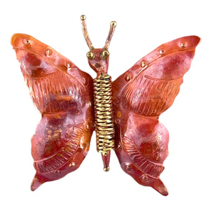 Handcrafted copper butterfly pendant with coiled body, brass antennae, and golden tail detail
