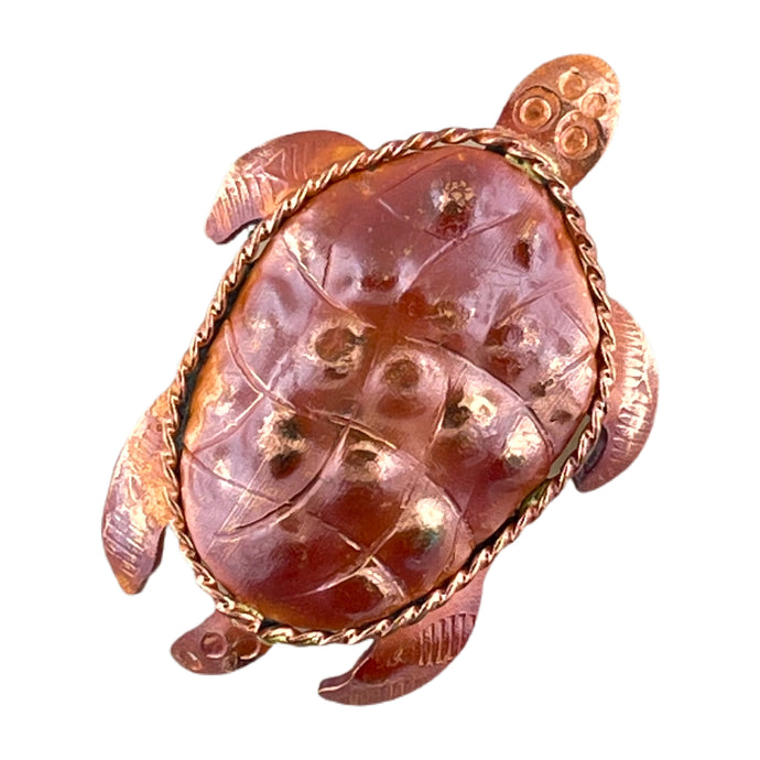 Small handcrafted copper sea turtle pendant with hand-stamped shell texture, repoussé body shaping, brass accent, and flame-torched red patina, designed by Patricia Healey.