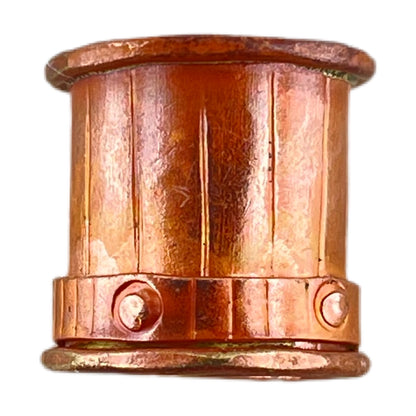 Close-up of copper end cap with brass rivets and stamped detail, flame-torched finish