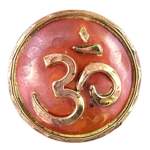 Copper Om pendant with brass detailing, flame-finished in red and orange, handcrafted by Patricia Healey