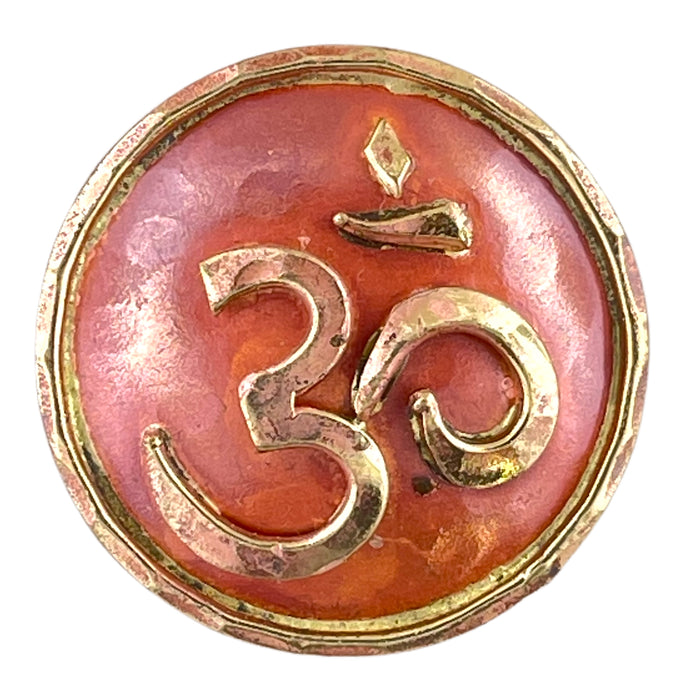 Copper Om pendant with brass detailing, flame-finished in red and orange, handcrafted by Patricia Healey