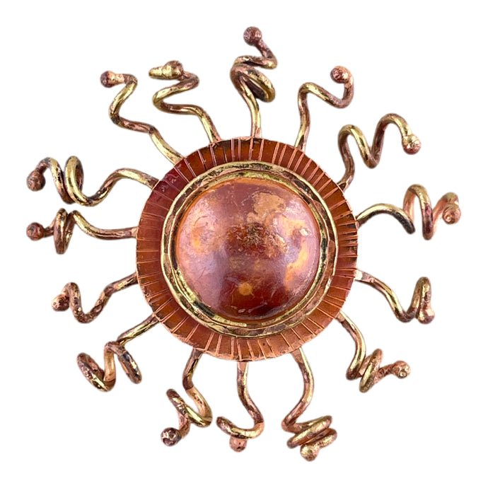 Handcrafted copper sunburst pendant with domed center, brass rays, and red-orange torch-fired patina by Patricia Healey